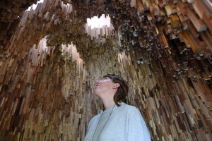 Artist Katie Paterson inside wooden artwork structure: Hollow