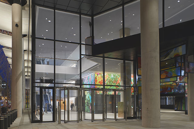 Images of nature in coloured glass panels within concrete building